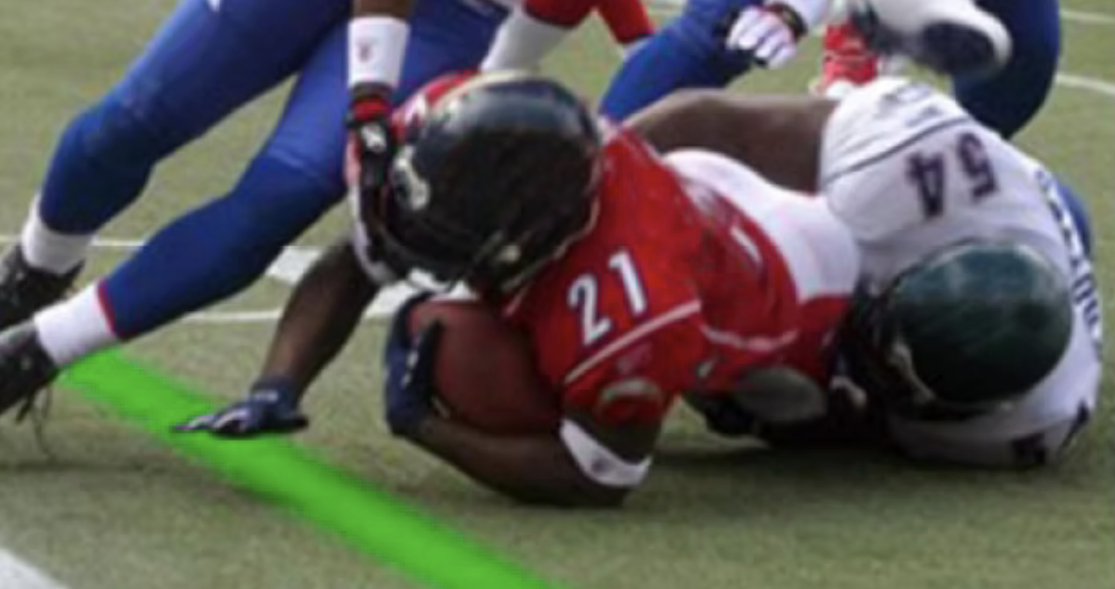Players reaching for the visible green laser line on the field